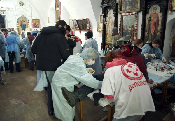 Anti-government protesters receive medical treatment inside Mikhailovsky Zlatoverkhy Cathedral (St. Michael's golden-domed cathedral) in Kiev during the early hours February 19, 2014