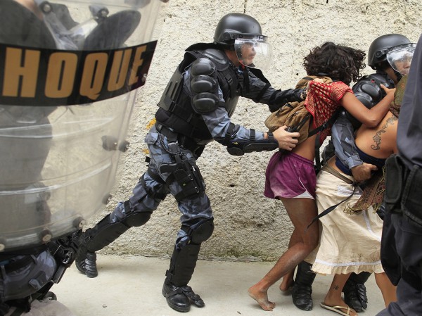 Police officers clash with supporters of the native Indian community during a protest outside the Indian museum in Rio de Janeiro