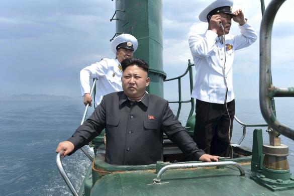 North Korean leader Kim Jong Un stands on the conning tower of a submarine during his inspection of the KPA Naval Unit 167