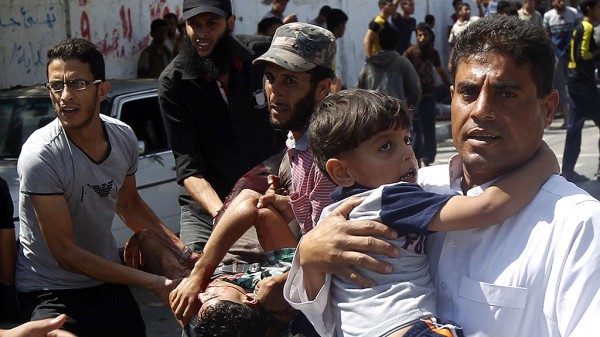 Palestinians carry injured people follow