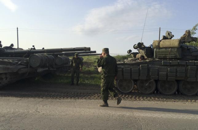 A picture shows a military convoy on the road side of the Russian southern town of Matveev Kurgan, near the Russian-Ukrainian border in Rostov region, Russia, May 26, 2015. REUTERS/Maria Tsvetkova