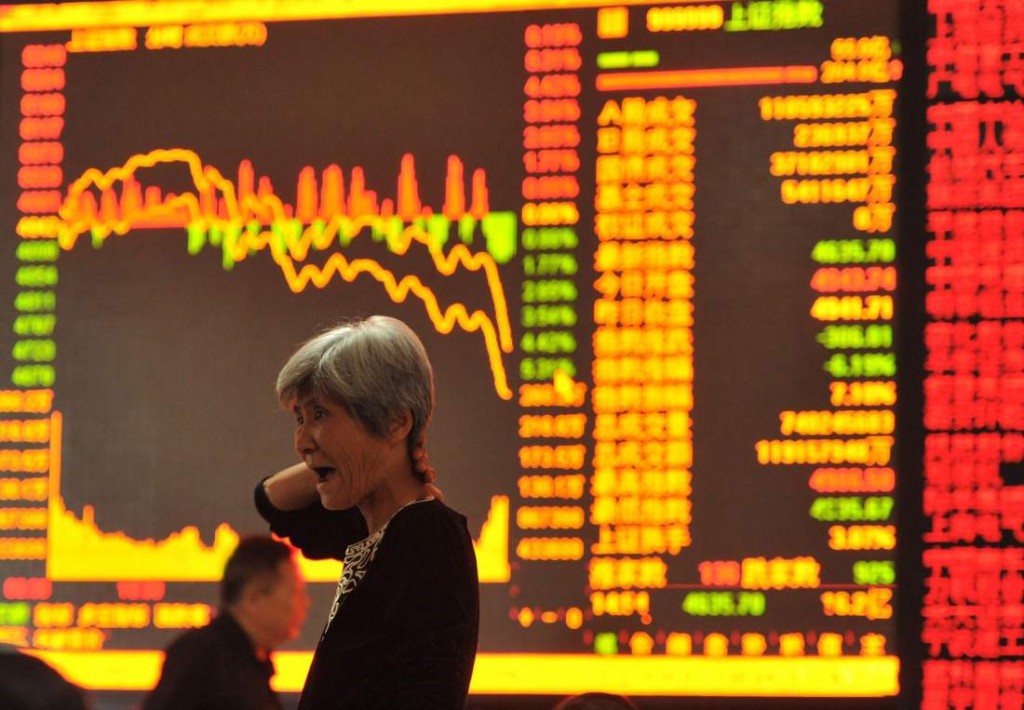 A stock investor gestures as she checks share prices at a security firm in Fuyang, east China's Anhui province on May 28, 2015. Chinese stocks plunged 6.5 percent on May 28 on concerns over tight liquidity and stricter requirements for margin trading, after closing at a more than seven-year high the previous day, dealers said.   AFP PHOTO    CHINA OUT        (Photo credit should read STR/AFP/Getty Images)