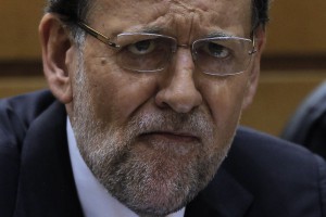 Spain's Prime Minister Mariano Rajoy listens the debate during a Spanish Parliament session in Madrid, Spain, Thursday, Aug. 1, 2013. Rajoy brushed off demands he should resign after text messages emerged showing him comforting a former political party treasurer under investigation over a slush fund and secret Swiss bank accounts. The spectacle of alleged greed and corruption has enraged Spaniards hurting from austerity and sky high unemployment. (AP Photo/Andres Kudacki)