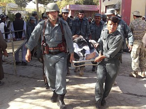Afghan policemen carry the body of a civilian after a bomb blast in Faryab province October 26, 2012. A suicide bomber killed at least 40 people in a mosque in Afghanistan's relatively peaceful north on Friday as worshippers gathered for prayers marking the Muslim Eid al-Adha holiday, police officials said. REUTERS/Stringer (AFGHANISTAN - Tags: CIVIL UNREST RELIGION TPX IMAGES OF THE DAY)