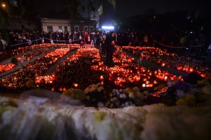 Persoane ce au participat la un mars al tacerii, aprind candele in memoria celor decedati in incendiul din Clubul Colectiv din Capitala, vineri, 6 noiembrie 2015. Aproximativ 600 de persoane s-au adunat, vineri, in parcul din Piata Unirii, de unde au plecat spre locul tragediei, intr-un mars al tacerii, la o saptamana dupa incendiul in urma caruia si-au pierdut viata 32 de persoane. Cei care au participat la mars au aprins candele, in semn de omagiu adus victimelor, pe asfaltul din fata complexului de cladiri in care se afla clubul. ANDREEA ALEXANDRU / MEDIAFAX FOTO