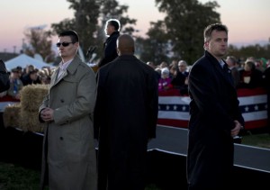 Secret Service agents stand watch as Republican presidential candidate, former Massachusetts Gov. Mitt Romney speaks during a campaign rally at the Shelby County Fairgrounds on Wednesday, Oct. 10, 2012 in Sidney, Ohio. (AP Photo/ Evan Vucci)
